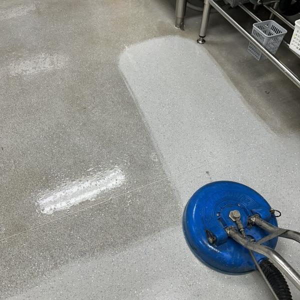 Machine scrubbing a tiled floor